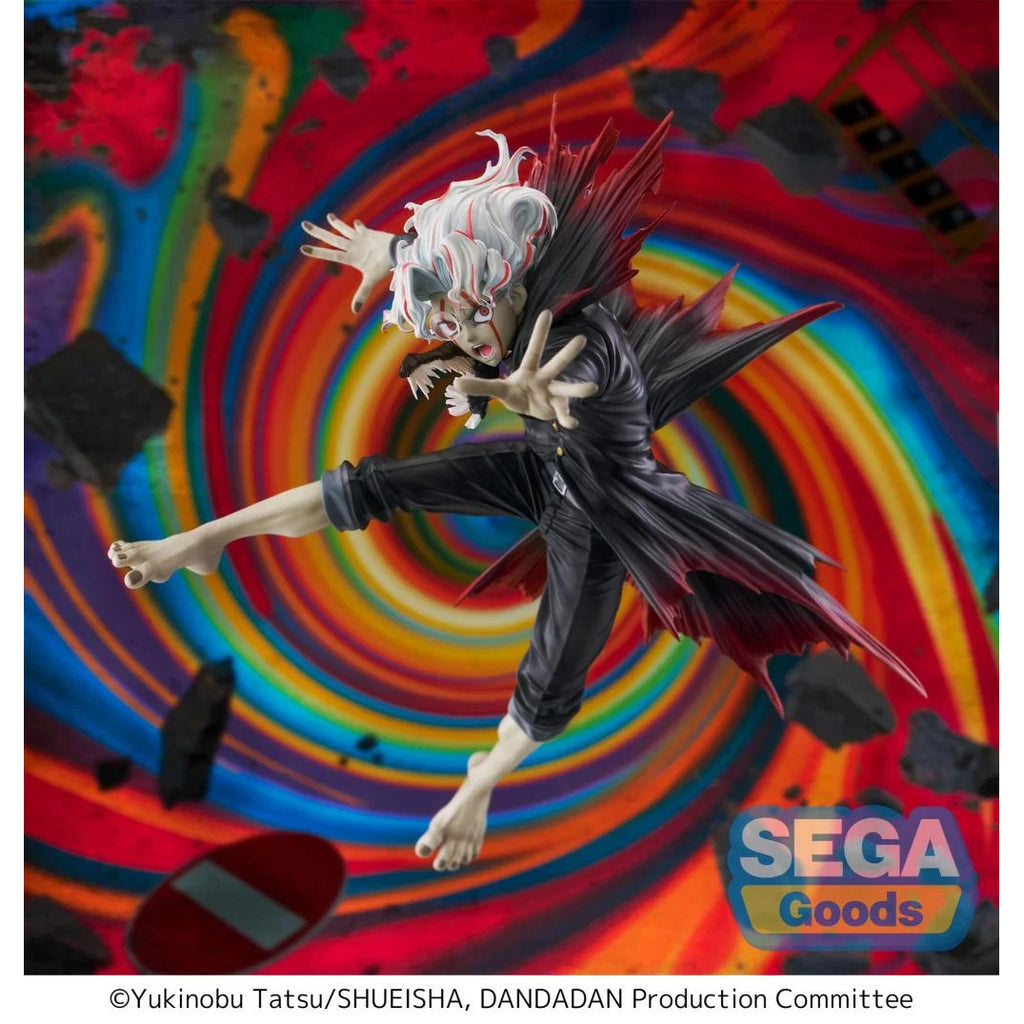 A colorful action figure of a character with white hair and black attire, posed dynamically against a vibrant, swirling colorful background. The figure is labeled with 'SEGA Goods' and there is Japanese text present.