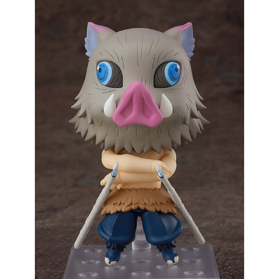 A Nendoroid figure of Inosuke Hashibira from Demon Slayer, featuring a boar-like character with a predominantly gray color with touches of pink and blue, wearing a simplistic brown and blue outfit.